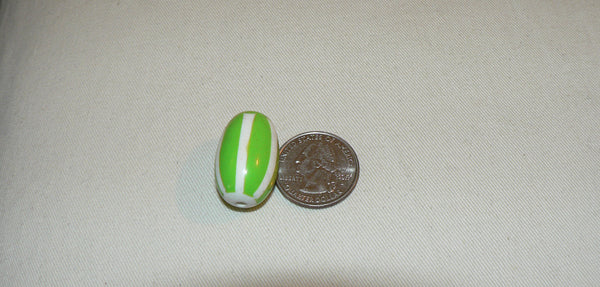 Candy Cane Bead Next to a Quarter